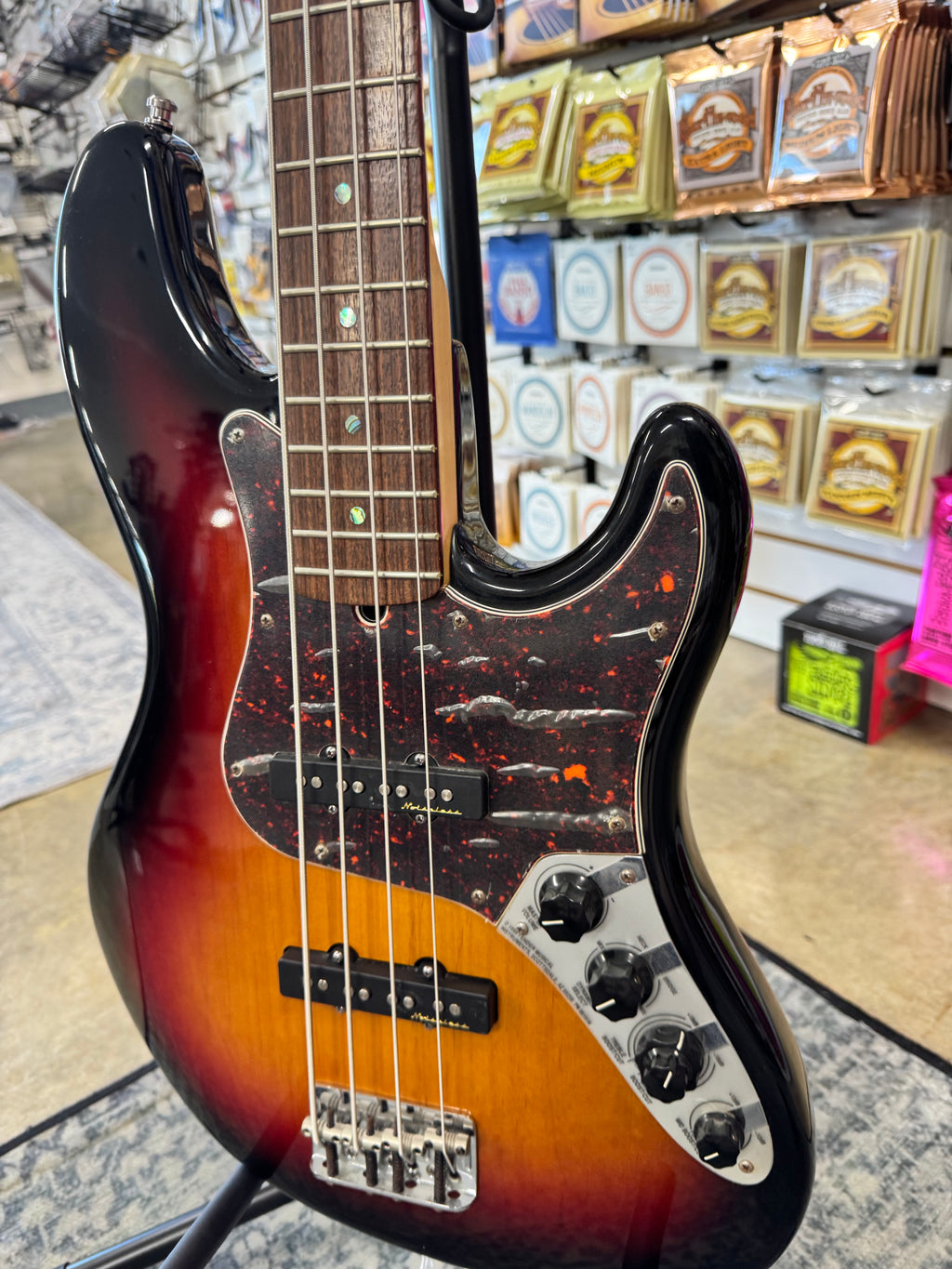 Used 2003 Fender American Deluxe Jazz Bass, 3-Color Sunburst - angled body view, other side