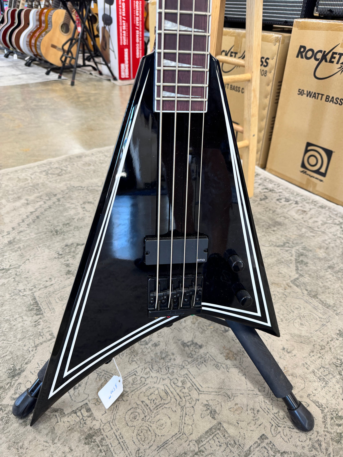 Used Jackson X Series Rhoads RR-B IV bass, Black with white pinstripes - Rhoads V body front