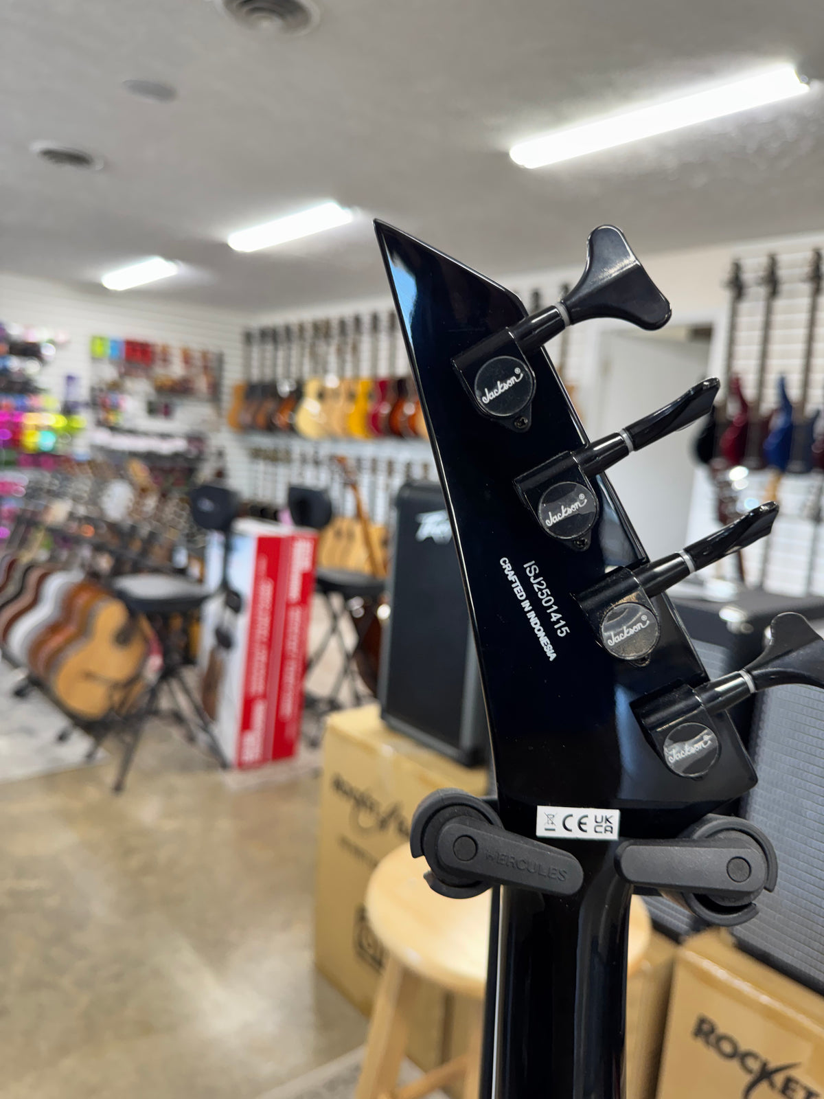 Used Jackson X Series Rhoads RR-B IV bass, Black with white pinstripes - back of headstock and tuners
