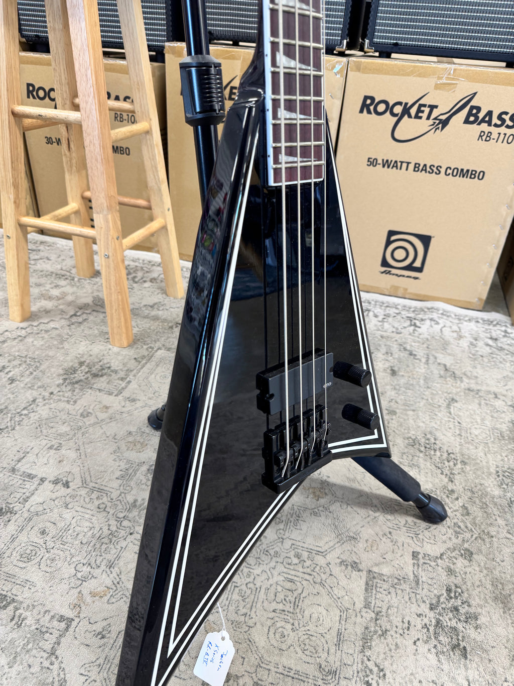 Used Jackson X Series Rhoads RR-B IV bass, Black with white pinstripes - angled body view