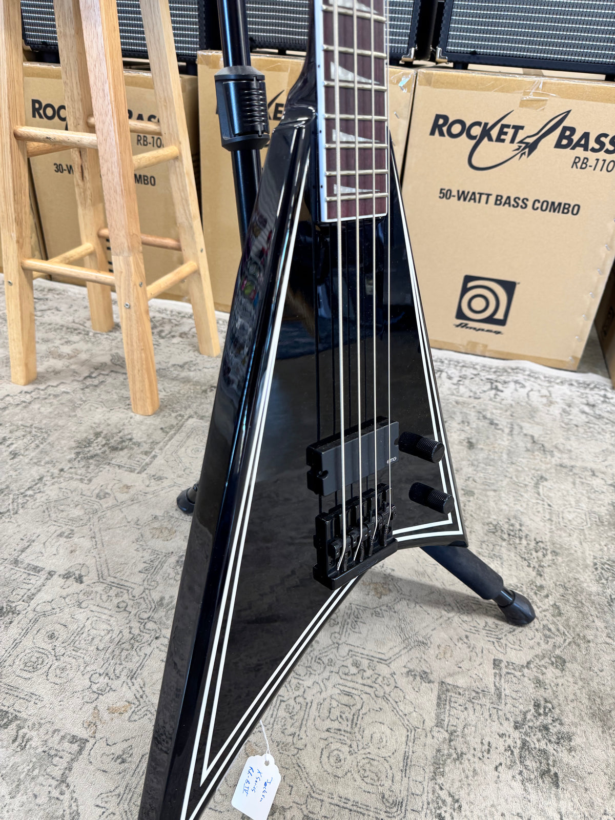 Used Jackson X Series Rhoads RR-B IV bass, Black with white pinstripes - angled body view