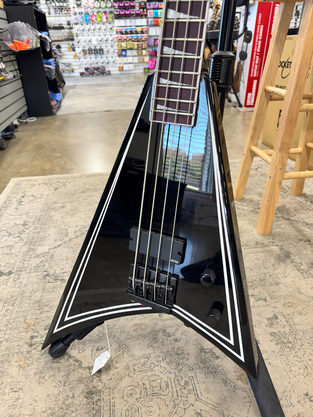 Used Jackson X Series Rhoads RR-B IV bass, Black with white pinstripes - angled body view, other side