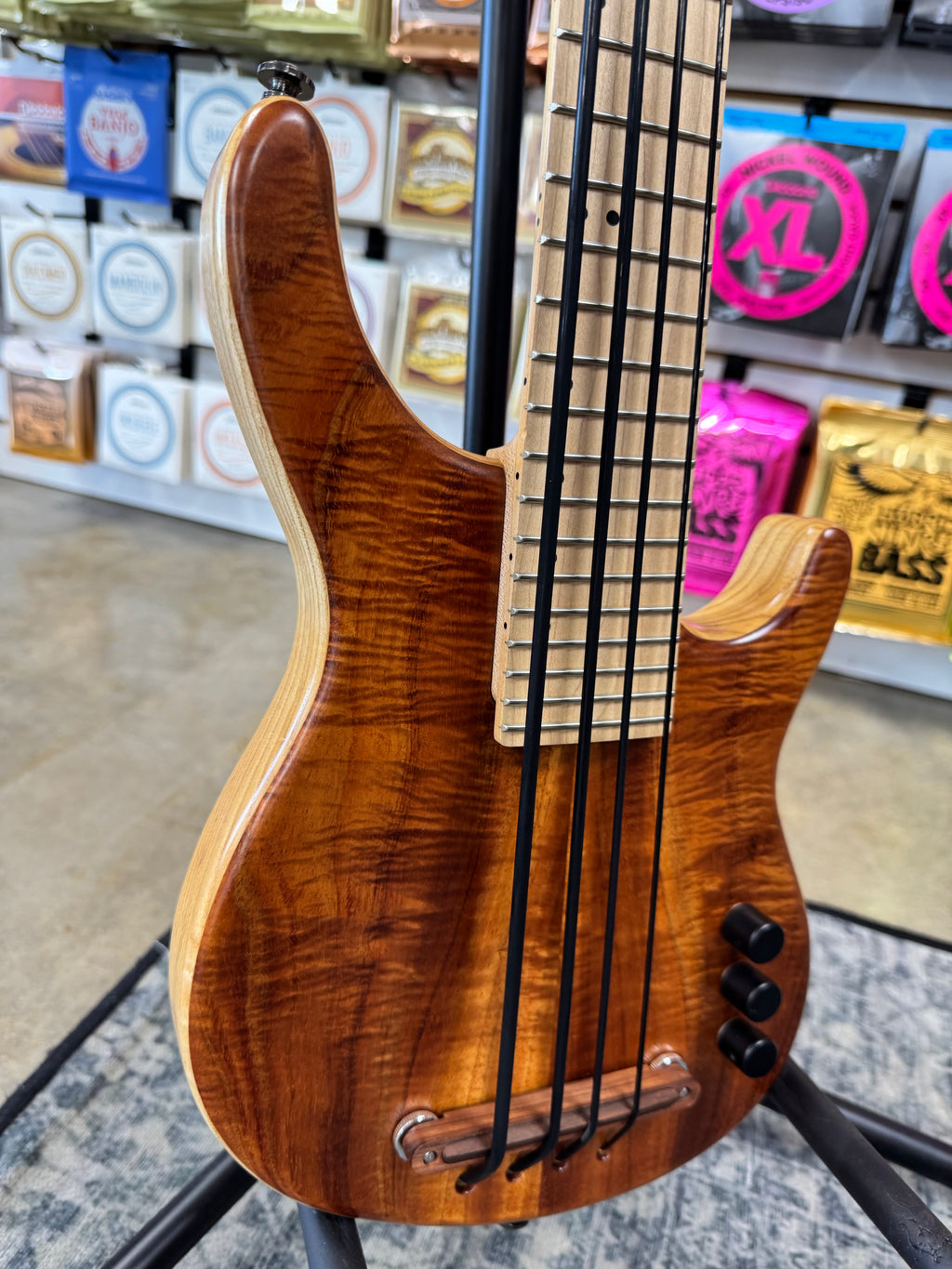 Used Kala Hawaiian Koa California U-Bass, Natural - angled view of koa top