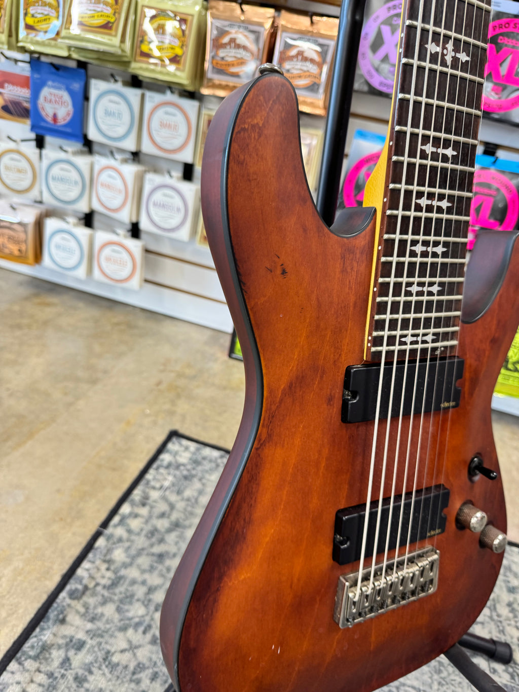 Used Schecter Omen-8 8-string guitar, Walnut Satin - angled body view