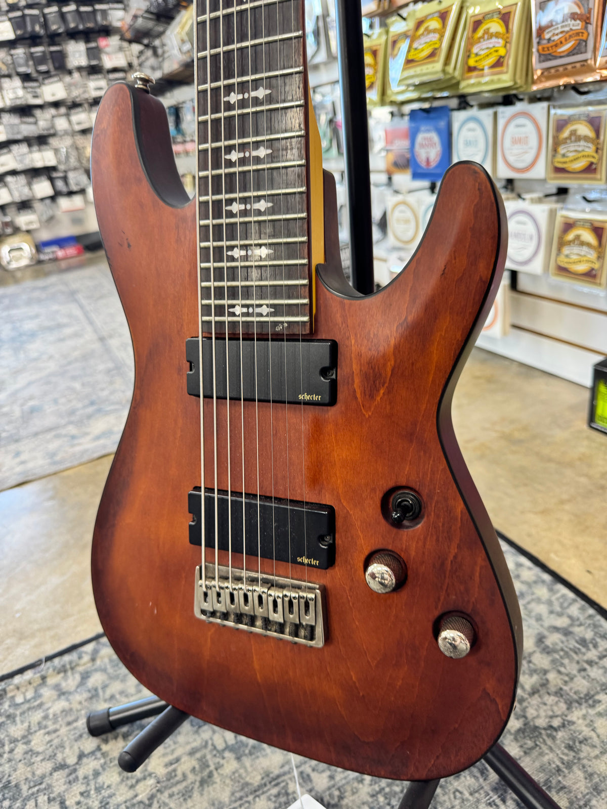Used Schecter Omen-8 8-string guitar, Walnut Satin - angled body view, other side
